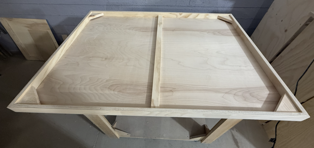 Back of large birch painting panel showing internal frame construction